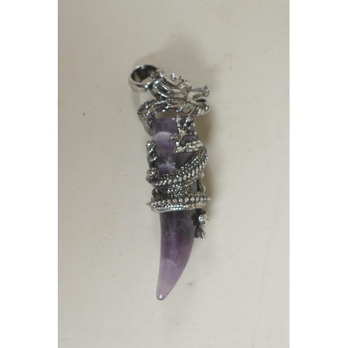 671 - A metal mounted amethyst pendant with dragon decoration, 6cm