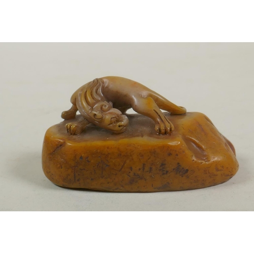 68 - A Chinese carved soapstone seal with a kylin knop, 9cm long