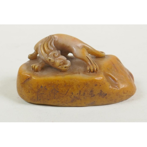 68 - A Chinese carved soapstone seal with a kylin knop, 9cm long