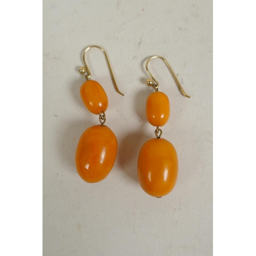 681 - Pair of butterscotch amber two bead earrings, largest beads 21mm, 6.7g overall