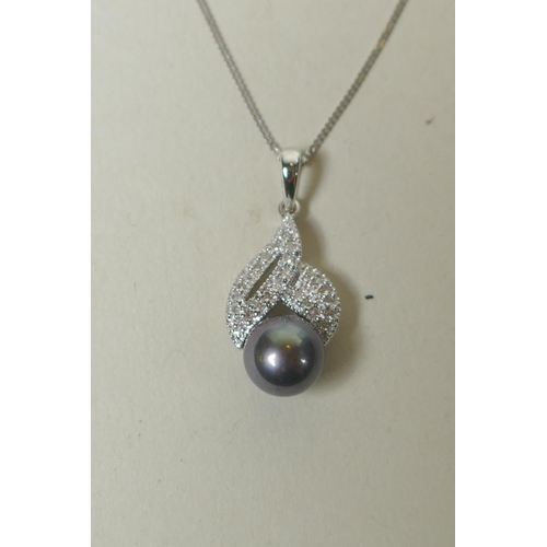 682 - 9ct white gold pendant set with diamonds and a Tahitian pearl, on a chain, 3.2g gross