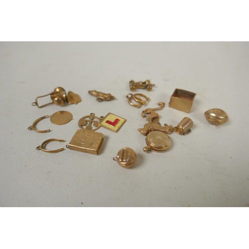 688 - A collection of 9ct gold charms, 15g, and a silver gilt charm in the form of a vintage racing car