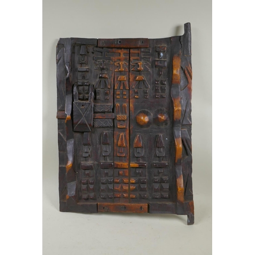 73 - An African carved wood Dogon Granary Door, 37 x 55cm