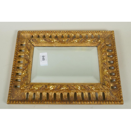 848 - A C19th Florentine carved and watergilt frame with pierced border and inset with bevelled mirror gla... 