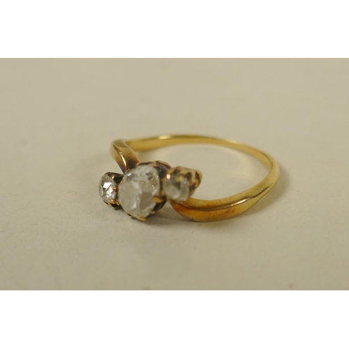 694 - An antique unmarked gold ring set with an old cut pear shaped diamond, approx 0.75ct, flanked by old... 