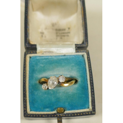 694 - An antique unmarked gold ring set with an old cut pear shaped diamond, approx 0.75ct, flanked by old... 