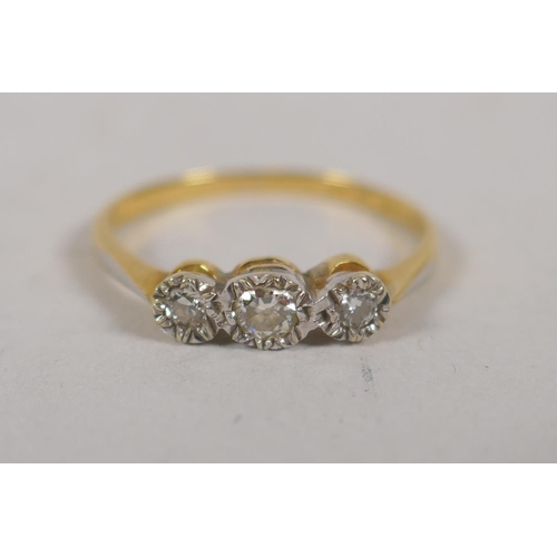 695 - A high carat gold and platinum three stone diamond ring, size N/O