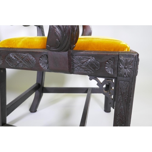 1005 - A pair of Chippendale style mahogany elbow chairs with pierced ladder backs and carved arms and rail... 