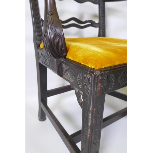 1005 - A pair of Chippendale style mahogany elbow chairs with pierced ladder backs and carved arms and rail... 