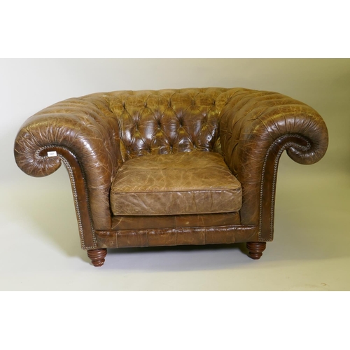 1007 - An oversize buttoned leather chesterfield armchair, 142 x 115cm deep, 78cm high