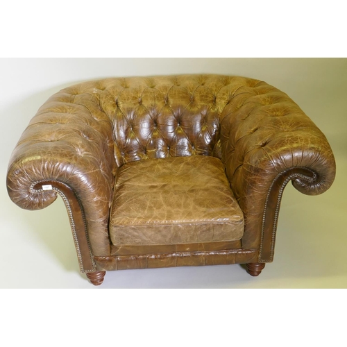 1007 - An oversize buttoned leather chesterfield armchair, 142 x 115cm deep, 78cm high