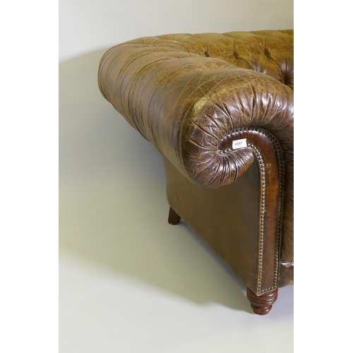 1007 - An oversize buttoned leather chesterfield armchair, 142 x 115cm deep, 78cm high