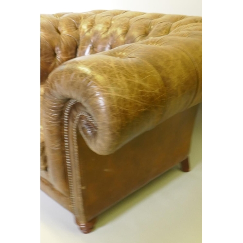 1007 - An oversize buttoned leather chesterfield armchair, 142 x 115cm deep, 78cm high