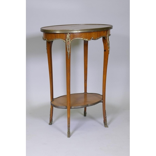 1008 - A French parquetry inlaid kingwood lamp table with ormolu mounts, raised on sabre supports with ormo... 