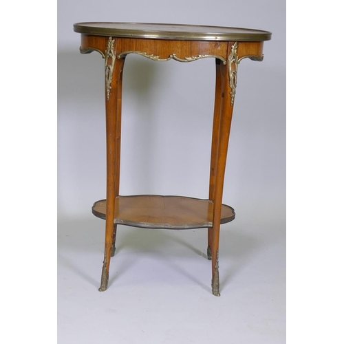 1008 - A French parquetry inlaid kingwood lamp table with ormolu mounts, raised on sabre supports with ormo... 