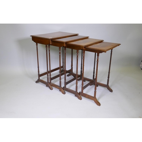 1009 - A nest of four inlaid kingwood occasional tables, raised on slender ring turned supports, 60 x 40 x ... 