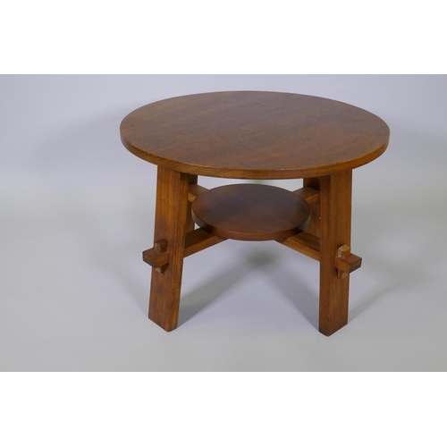 1010 - An Arts & Crafts style walnut occasional table raised on square supports united by an under tier... 