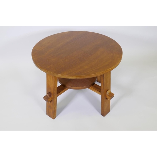 1010 - An Arts & Crafts style walnut occasional table raised on square supports united by an under tier... 