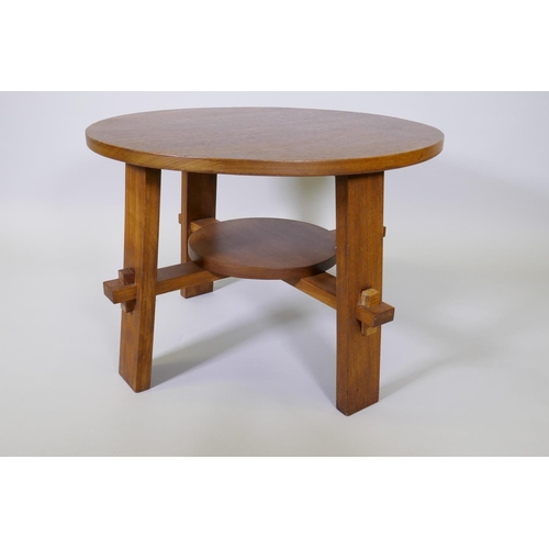 1010 - An Arts & Crafts style walnut occasional table raised on square supports united by an under tier... 