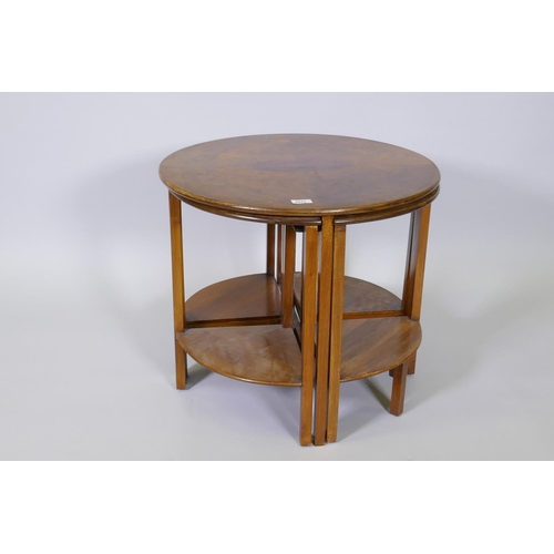 1011 - A 1930s figured walnut nest of five tables, 61cm diameter x 54cm high