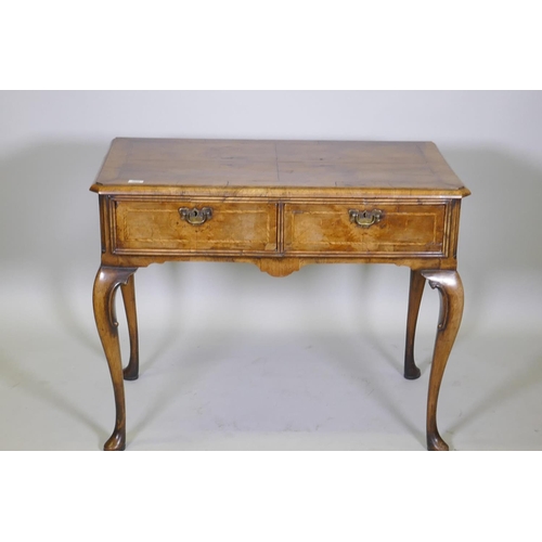 1020 - A Georgian style walnut low boy with two drawers and cabriole supports, 100 x 53cm, 80cm high