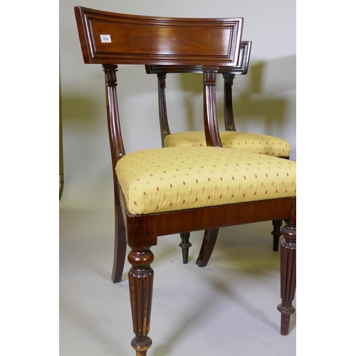 1024 - A good set of four early C19th mahogany bar back hairs, with moulded backs and pad seats, raised on ... 