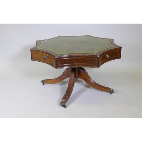 1026 - A drum type occasional table, with leather inset top over four true and four false drawers, raised o... 