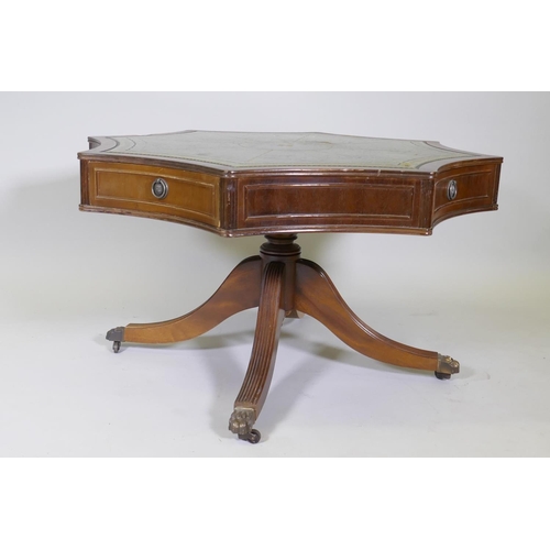 1026 - A drum type occasional table, with leather inset top over four true and four false drawers, raised o... 