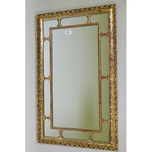 1028 - A giltwood and composition sectional wall mirror, 83 x 53cm