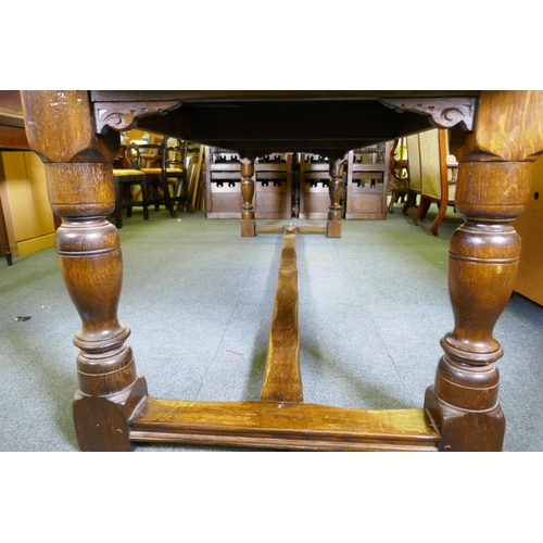 1032 - A William and Mary style oak refectory table, with planked top and carved frieze, raised on baluster... 