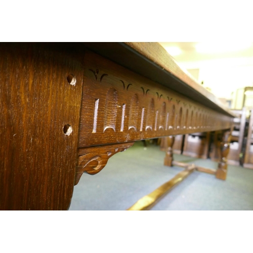 1032 - A William and Mary style oak refectory table, with planked top and carved frieze, raised on baluster... 