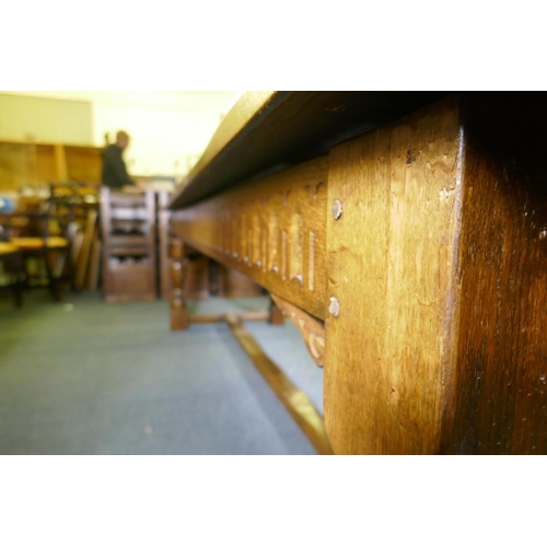 1032 - A William and Mary style oak refectory table, with planked top and carved frieze, raised on baluster... 