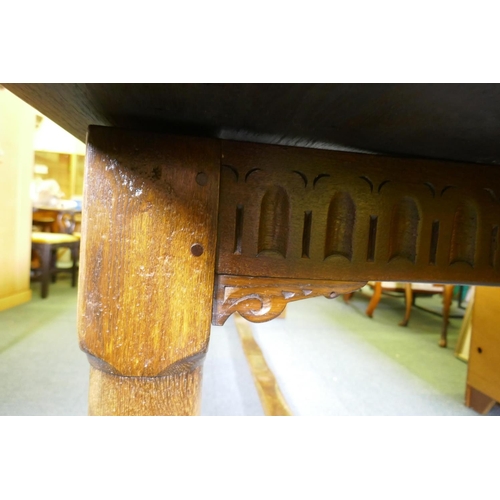 1032 - A William and Mary style oak refectory table, with planked top and carved frieze, raised on baluster... 