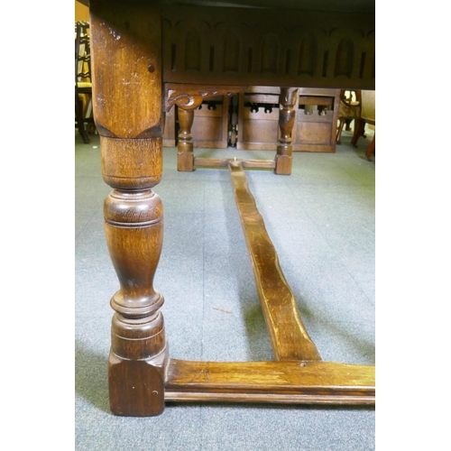 1032 - A William and Mary style oak refectory table, with planked top and carved frieze, raised on baluster... 