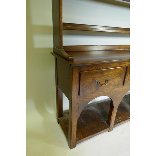 1033 - A Georgian style oak pot board dresser, with open delft rack over four drawers, raised on square cha... 