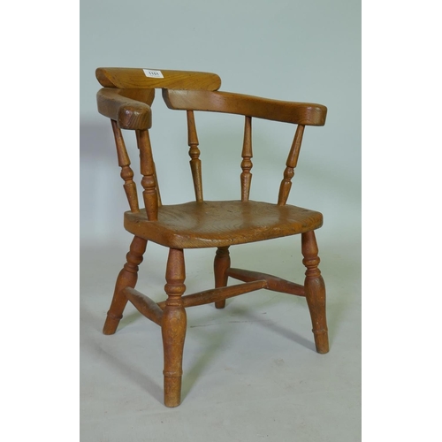 1151 - A C19th child's elm bow back armchair, 50cm high