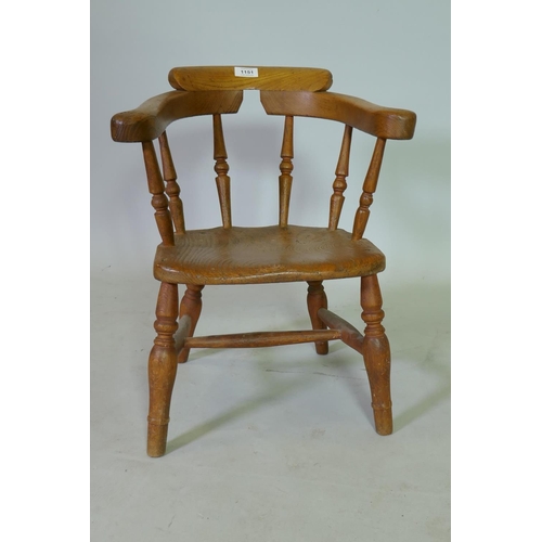 1151 - A C19th child's elm bow back armchair, 50cm high