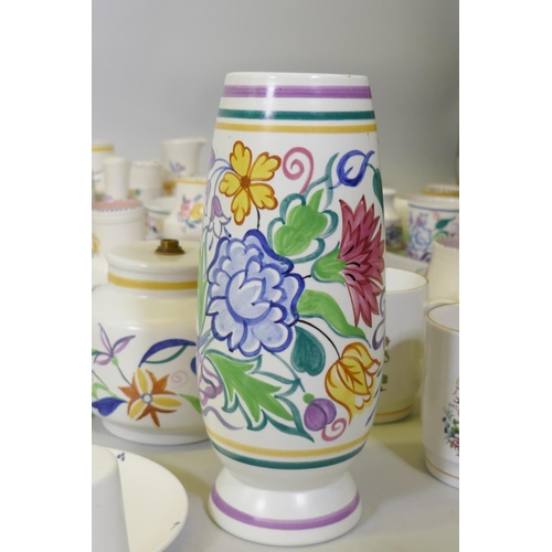 16 - A large collection of Poole Pottery in the traditional pattern, 1940s and later