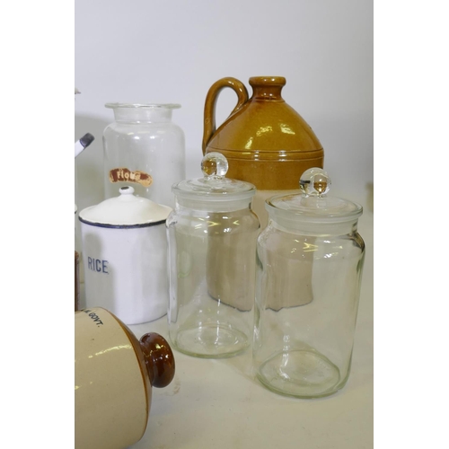 26 - A quantity of vintage kitchenalia, enamel storage jars, a bread bin, glass jars, stoneware demi john... 