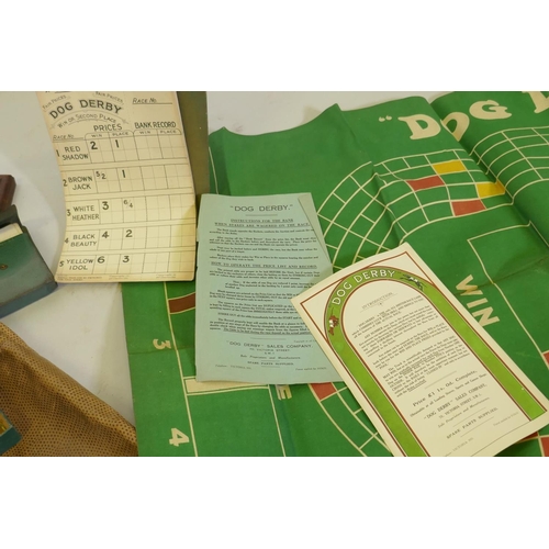 27 - A collection of vintage games, dominoes, cribbage, playing cards and 'Dog Derby'