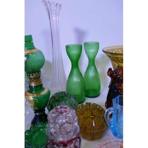 40 - A large collection of antique and later glassware, vases, tazza, carnival glass dishes, jelly moulds... 