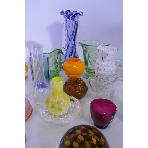 40 - A large collection of antique and later glassware, vases, tazza, carnival glass dishes, jelly moulds... 