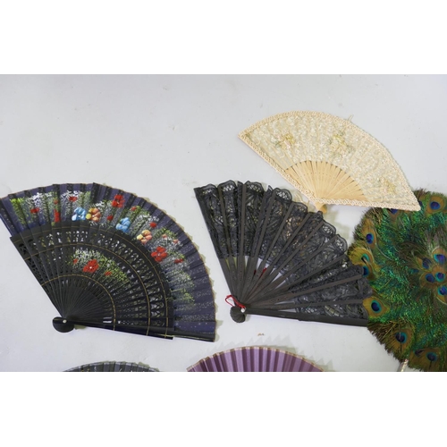 42 - An antique peacock feather fan, 33cm diameter, ostrich feather fans, lace and other fans