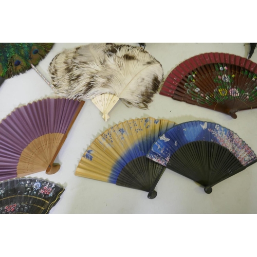 42 - An antique peacock feather fan, 33cm diameter, ostrich feather fans, lace and other fans