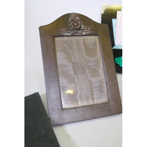 44 - A collection of items related to WWII and the Royal Artillery, leather photo frame with bronze mount... 