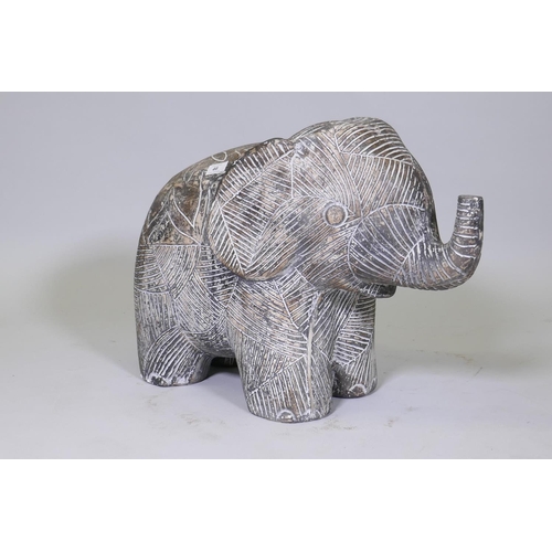 46 - A carved and painted model of a young elephant, 44cm high