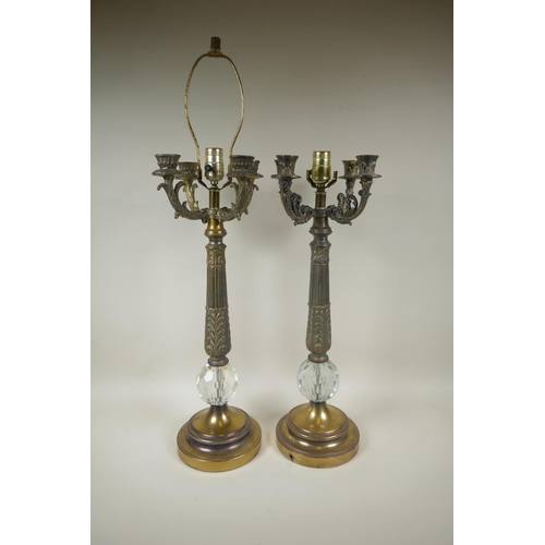 49 - A near pair of bronzed metal and faceted glass four branch column table lamps, 59cm high