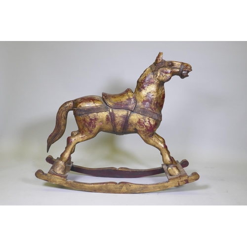 64 - A carved wood rocking horse with painted and parcel gilt decoration, 88cm high