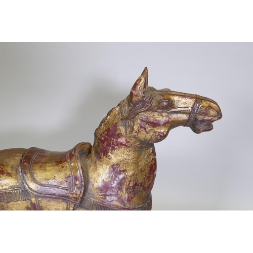 64 - A carved wood rocking horse with painted and parcel gilt decoration, 88cm high