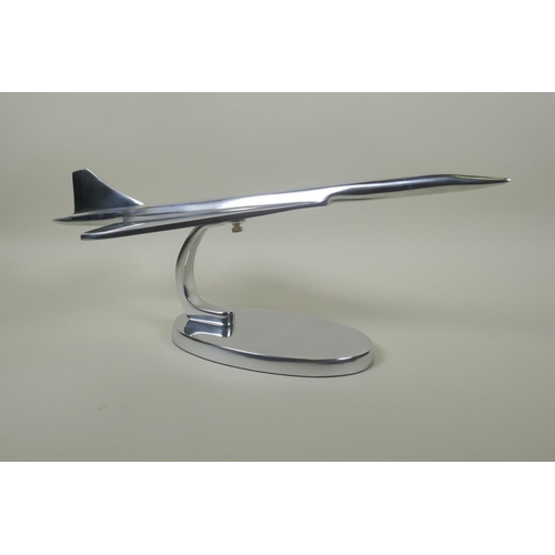 66 - A chromed metal desk model of Concorde, 42cm long